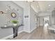 Bright and modern foyer with wood-look floors, unique mirror decor, and stylish console table at 1901 Kansas Ne Ave, St Petersburg, FL 33703