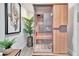 Indoor infrared sauna for health and wellness, featuring natural wood and a glass door at 1901 Kansas Ne Ave, St Petersburg, FL 33703