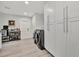 Bright laundry room with sleek front-load machines, ample storage cabinets, and a rolling bar at 1901 Kansas Ne Ave, St Petersburg, FL 33703