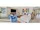 Cozy living area with a stone fireplace, large TV, and comfortable seating arrangement at 1901 Kansas Ne Ave, St Petersburg, FL 33703