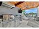 Outdoor kitchen with stainless steel appliances, stone counter, and a stunning view of the water at 1901 Kansas Ne Ave, St Petersburg, FL 33703