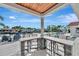 A shaded outdoor kitchen overlooks a waterfront pool, a beautiful view, and patio seating at 1901 Kansas Ne Ave, St Petersburg, FL 33703