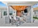 The outdoor kitchen includes a built in grill, mini fridge, mounted TV, and barstool seating at 1901 Kansas Ne Ave, St Petersburg, FL 33703