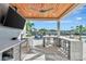 Elegant outdoor kitchen offers a marble counter, seating, and waterfront views for entertaining at 1901 Kansas Ne Ave, St Petersburg, FL 33703