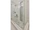Modern glass enclosed shower with decorative stone details and premium fixtures at 1901 Kansas Ne Ave, St Petersburg, FL 33703