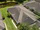 Aerial view of home showing roof, landscaping, and pond nearby at 19137 Lake Audubon Dr, Tampa, FL 33647