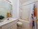 Clean bathroom with a tub and shower, tiled walls, and vanity at 19137 Lake Audubon Dr, Tampa, FL 33647