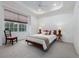 Inviting bedroom with a tray ceiling, comfortable bed, and a bright window view at 19137 Lake Audubon Dr, Tampa, FL 33647