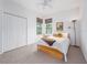 Bright bedroom with a double bed, closet, and two large windows at 19137 Lake Audubon Dr, Tampa, FL 33647