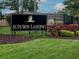 Audubon Landing community sign, featuring lush landscaping and a black fence at 19137 Lake Audubon Dr, Tampa, FL 33647