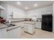 Functional kitchen with ample counter space, black appliances, and an island at 19137 Lake Audubon Dr, Tampa, FL 33647