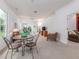 Bright and airy living room featuring neutral carpet, ceiling fan and natural light at 19137 Lake Audubon Dr, Tampa, FL 33647