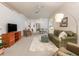 Cozy living room featuring a comfortable sofa, soft rug, and modern entertainment center at 19137 Lake Audubon Dr, Tampa, FL 33647