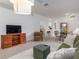 Spacious living room featuring comfortable furniture, a television, and seamless flow to other living areas at 19137 Lake Audubon Dr, Tampa, FL 33647