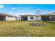 Well-manicured backyard with lush grass, a cozy patio, and tasteful landscaping at 1978 Pepper Grass Dr, North Port, FL 34289