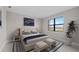 Comfortable bedroom featuring a large window, area rug, and a queen sized bed at 1978 Pepper Grass Dr, North Port, FL 34289