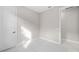 Empty bedroom featuring carpet flooring, white trim, and a door at 1978 Pepper Grass Dr, North Port, FL 34289