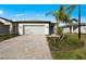 Beautiful single-story home with a paver driveway, two-car garage, and well-maintained landscaping at 1978 Pepper Grass Dr, North Port, FL 34289