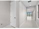 Bright hallway featuring neutral paint, tile flooring, and natural light at 1978 Pepper Grass Dr, North Port, FL 34289