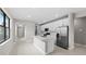 Open-concept kitchen with stainless steel appliances and a center island at 1978 Pepper Grass Dr, North Port, FL 34289