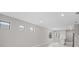 Open-concept living space with light-colored walls, tile floors, and multiple windows at 1978 Pepper Grass Dr, North Port, FL 34289