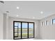 Bright living room features a sliding glass door leading outside and multiple windows at 1978 Pepper Grass Dr, North Port, FL 34289