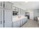 Elegant kitchen with modern appliances, white countertops, and abundant gray cabinetry for ample storage at 2132 Academy Dr, Clearwater, FL 33764