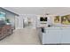 Open-concept living room with gray walls, recessed lighting, and a large sectional sofa at 2132 Academy Dr, Clearwater, FL 33764