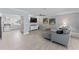 Comfortable living room next to a kitchen, featuring tile floors, a modern sofa, and stylish decor at 2132 Academy Dr, Clearwater, FL 33764