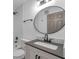 Updated bathroom with dark fixtures, subway tile, modern vanity and oval mirror at 2353 Shelley St # 6, Clearwater, FL 33765