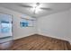 Bright bedroom with a ceiling fan, wood-look floors, and a view of an outdoor porch at 2353 Shelley St # 6, Clearwater, FL 33765