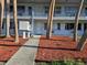An apartment entrance showcasing a walkway, mailbox, and well-kept mulch landscaping for a neat, inviting exterior at 2353 Shelley St # 6, Clearwater, FL 33765