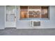 Home exterior with a white door, window, and an external air conditioning unit at 2353 Shelley St # 6, Clearwater, FL 33765