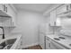 Compact kitchen with white cabinets, stone countertops, and modern appliances at 2353 Shelley St # 6, Clearwater, FL 33765