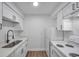 Bright kitchen features white cabinets, modern countertops, stainless steel sink, and appliances at 2353 Shelley St # 6, Clearwater, FL 33765