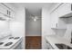 Kitchen view to bedroom, showcasing subway tile, white cabinets, modern countertops and flooring at 2353 Shelley St # 6, Clearwater, FL 33765