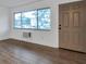 Living room featuring wood-look tile flooring, large window, and a front door at 2353 Shelley St # 6, Clearwater, FL 33765