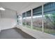 Enclosed sunroom featuring natural light and garden views through large windows at 2353 Shelley St # 6, Clearwater, FL 33765
