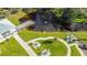 Scenic aerial view of a community pond with a fountain, dock, and picnic areas at 2447 Ecuadorian Way # 11, Clearwater, FL 33763