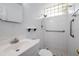 Bathroom includes a white vanity, toilet, walk-in shower, and patterned floor tiles at 2447 Ecuadorian Way # 11, Clearwater, FL 33763