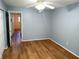 Spacious bedroom with wood floors, light blue walls, and ceiling fan at 2447 Ecuadorian Way # 11, Clearwater, FL 33763