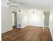 Light and airy dining room featuring modern light fixture and wood flooring at 2447 Ecuadorian Way # 11, Clearwater, FL 33763