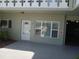 Front door with sidelight windows, exterior unit number, and adjacent carport at 2447 Ecuadorian Way # 11, Clearwater, FL 33763
