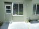 Exterior showcasing a backyard entrance door and windows with blinds for added privacy and shade at 2447 Ecuadorian Way # 11, Clearwater, FL 33763