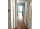 Bright hallway showcasing wood floors, leading to a naturally lit living space at 2447 Ecuadorian Way # 11, Clearwater, FL 33763
