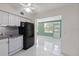 Kitchen with modern appliances, white cabinets, and ceramic tile flooring at 2447 Ecuadorian Way # 11, Clearwater, FL 33763