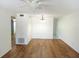 Bright living room featuring wood floors, fan, and light fixture at 2447 Ecuadorian Way # 11, Clearwater, FL 33763