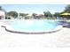 Large community pool with sunny skies and colorful umbrellas at 2447 Ecuadorian Way # 11, Clearwater, FL 33763
