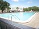Large community pool with clear blue water and plenty of seating at 2447 Ecuadorian Way # 11, Clearwater, FL 33763