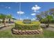 Entrance sign for the community golf course surrounded by manicured landscaping and blue skies at 2447 Ecuadorian Way # 11, Clearwater, FL 33763